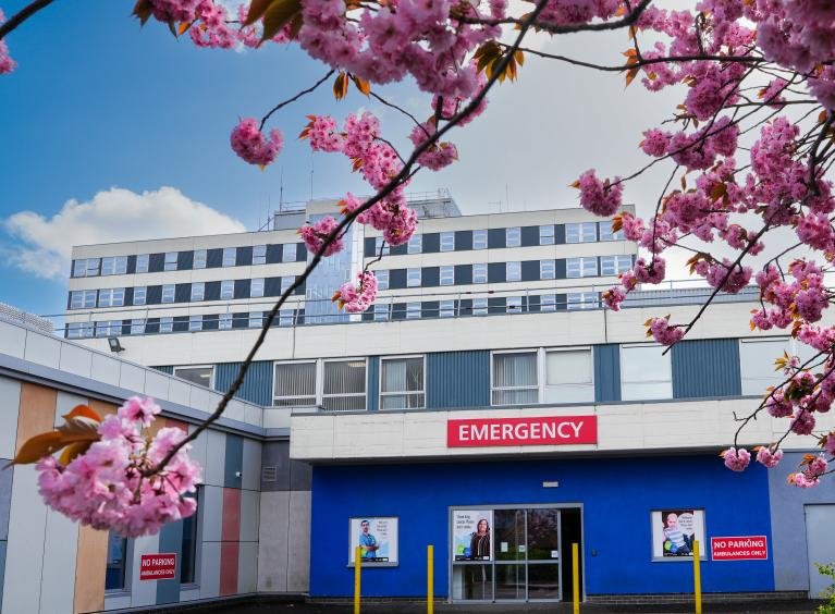 Emergency Department entrance with cherry blossom on the trees outside