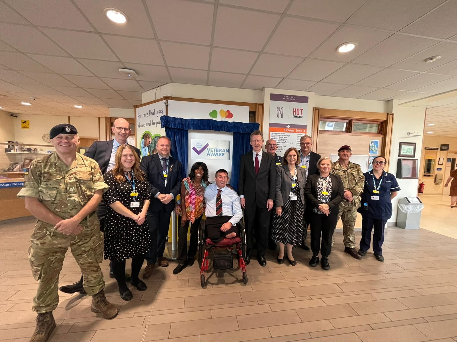 Dan Jarvis, MP for Barnsley Central stands with Ben Parkinson OBE and hospital staff in front of the Veteran Aware plaque