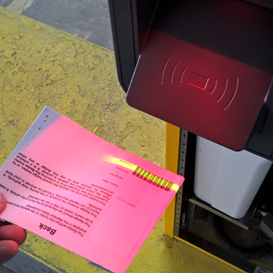 A person scanning their blue badge, in order to park at the hospital 