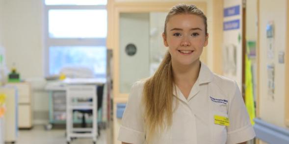 A dietician who works in ICU, smiles at the camera