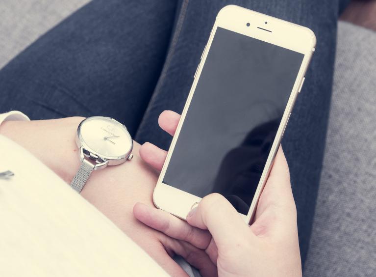 A person looks at their smart phone