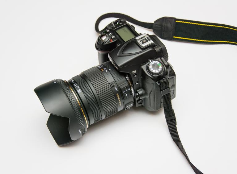 A DLSR camera sits on a white background.