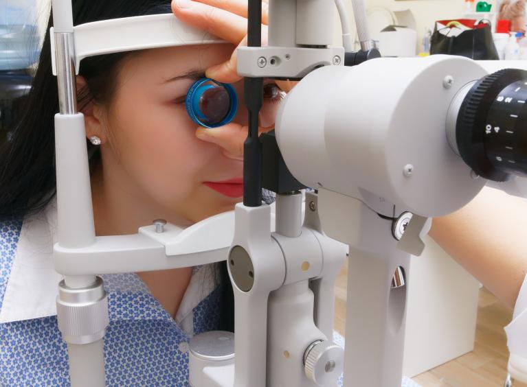 A person getting their eyes tested by an optician. 