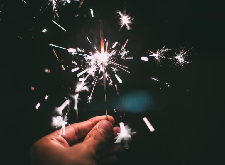 A person holds a sparkler.