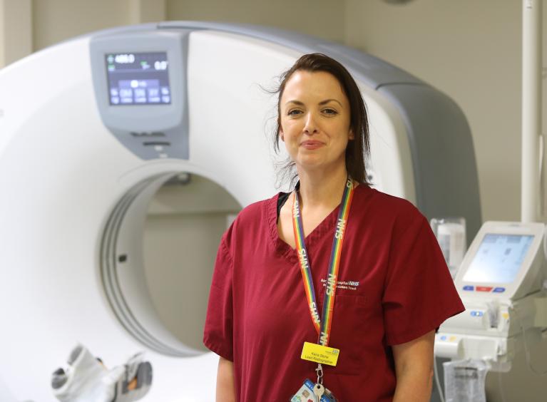 Radiographer Keira Stone stands in front of a scanner at Barnsley Hospital.