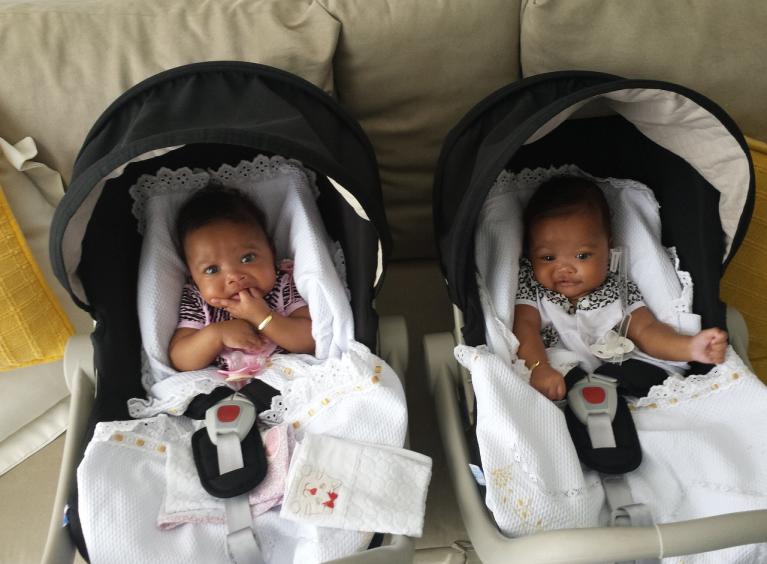 Twin babies in carry chairs