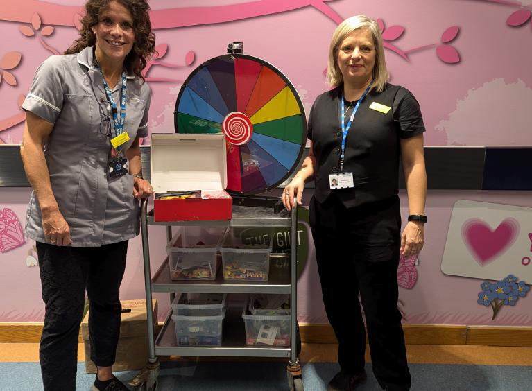 An image of Lucy with her trolley and wheel to engage patients who smoke