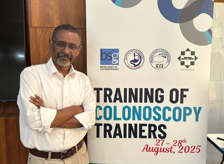 Dr Said with a banner: 'Training of Colonoscopy Trainers'