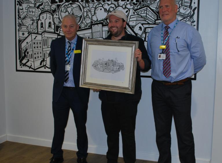 Michael Wright, Adam Briscoe and Dr Michael Enright in front of the Education Centre artwork.