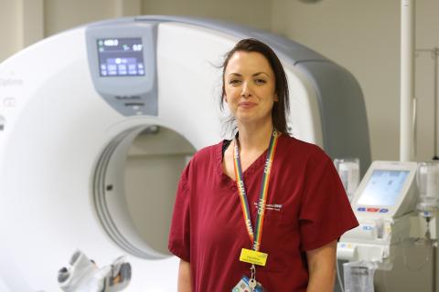 Radiographer Keira Stone stands in front of a scanner at Barnsley Hospital