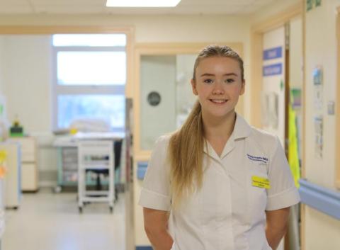 A dietician who works in ICU, smiles at the camera
