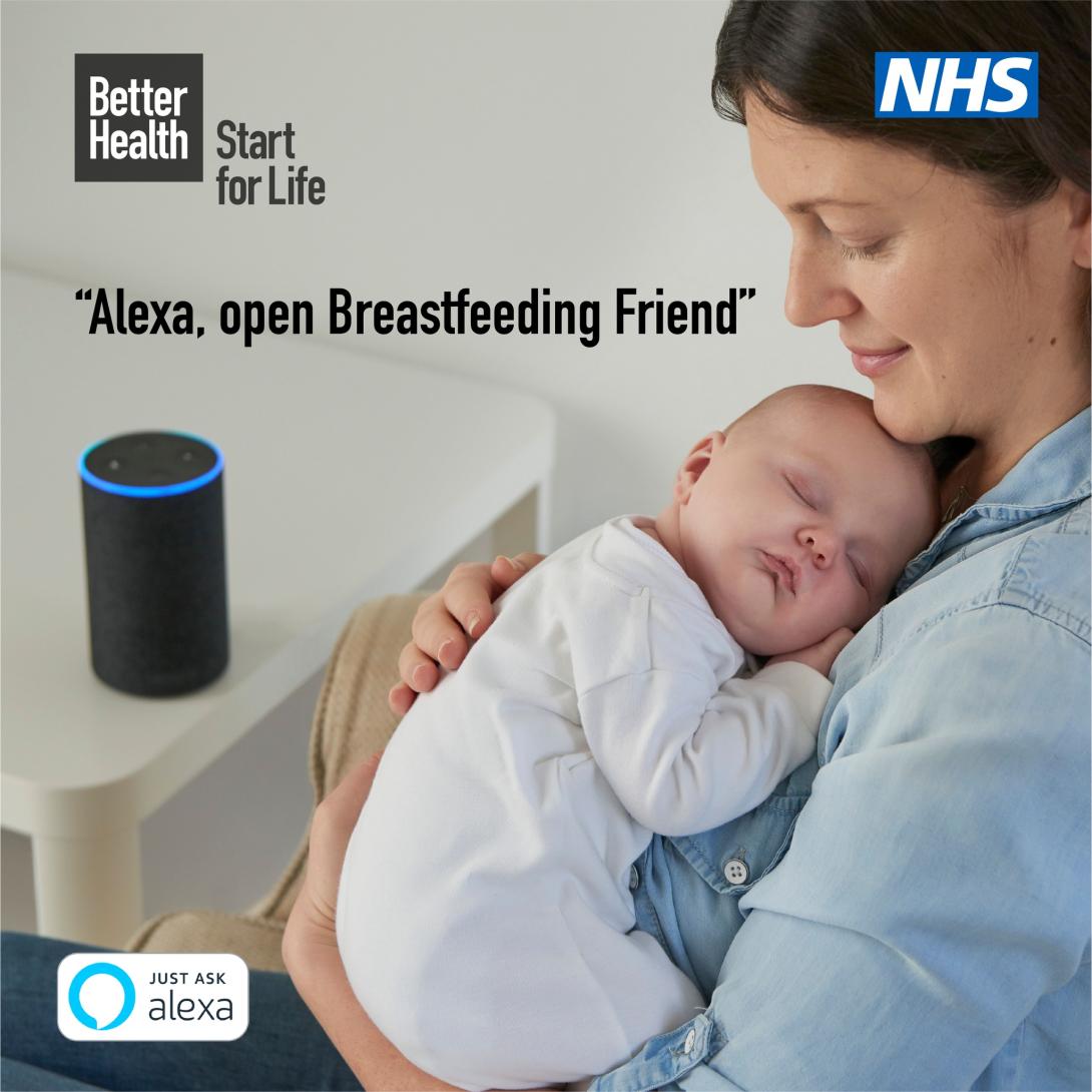 A parent holding their baby listens to their smart speaker
